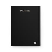 Back cover of black hardcover journal with sample name 'Dr. Medina' and a small production barcode