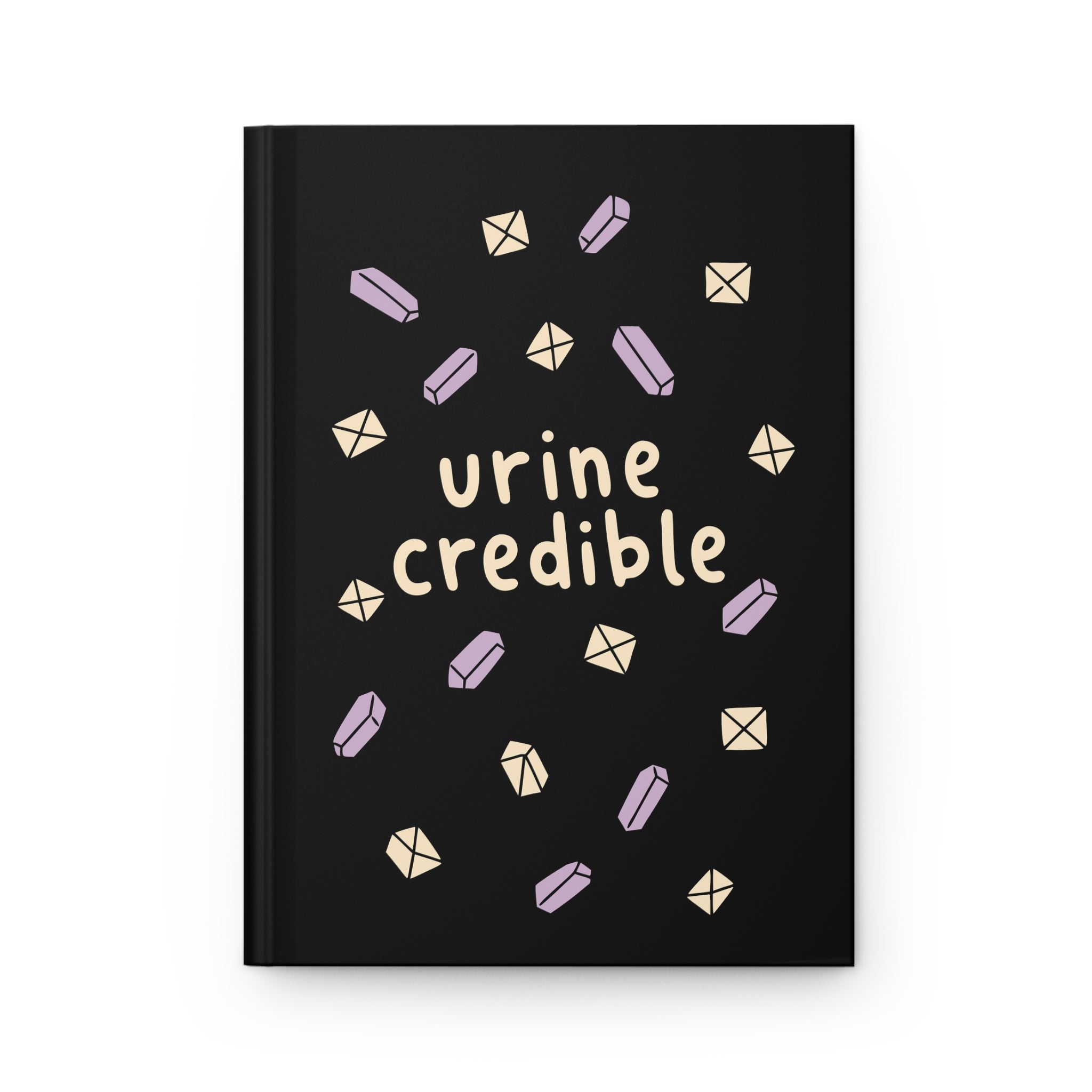 Front cover of a black hardcover journal with cream 'urine credible' lettering and lavender and cream crystals