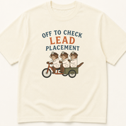 Garment-dyed unisex t-shirt printed with 'Off to Check Lead Placement' — Cardiology humor tee for Emergency Medicine, EMS/Paramedic, and Nursing professionals.