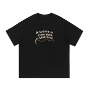 Mockup of black cotton T-shirt with a needle and thread with the words "A suture in time doth save nine".