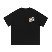 Mockup of a black cotton T-shirt with a small open book graphic reading 'the plural of anecdote is not evidence'
