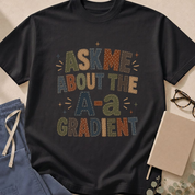 Garment-dyed unisex t-shirt printed with "Ask Me About the a/A Ratio" — pulmonology humor tee in dark faux patchwork design