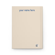 Cream hardcover journal back cover reading 'your name here' with a small barcode at the bottom