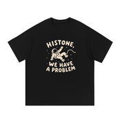 Mockup of a black cotton T-shirt with a floating cartoon astronaut and the text 'Histone, We Have a Problem'