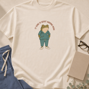 Garment-dyed unisex t-shirt in Bay printed with 'It Sure Is Quiet Around Here' beside a wide-eyed frog graphic — ER and ICU jinx humor tee for nurses and paramedics.
