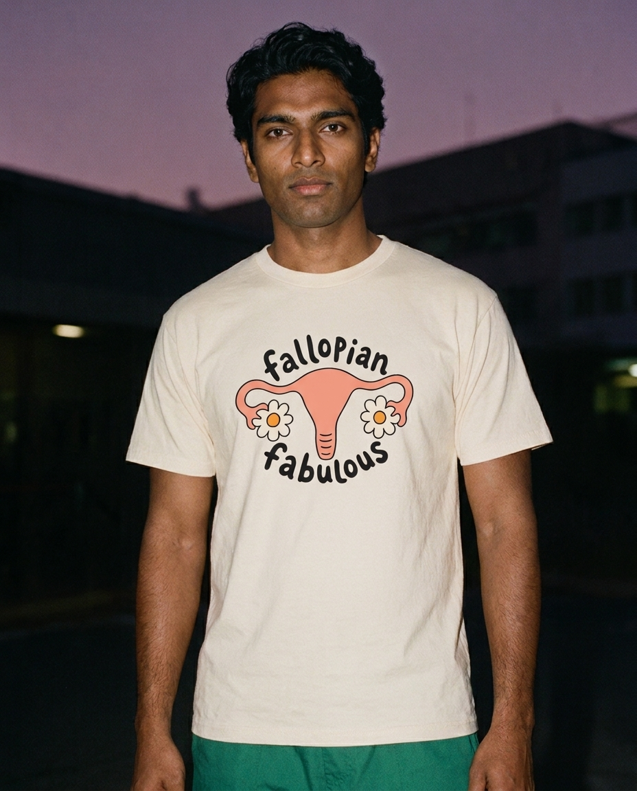 Man photographed with flash at night, wearing an apricot cotton T-shirt with the Fallopian Fabulous design.