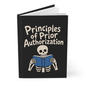 Mockup of a black hardcover journal slightly open, cover reads 'Principles of Prior Authorization' with a skeleton and blue book