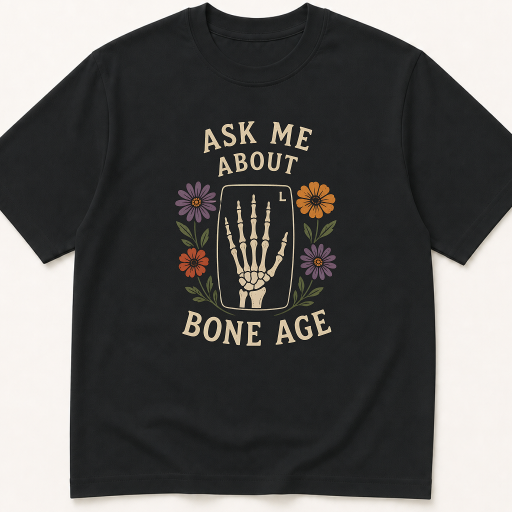 Garment-dyed unisex t-shirt printed with 'Ask Me About Bone Age' — Orthopedics humor tee for Pediatric Endocrinology, Pediatrics, and Radiology professionals.