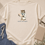 Garment-dyed unisex t-shirt featuring a cartoon owl design with 'Cardi-OWL-ogist' text — a cardiology pun tee for cardiologists.