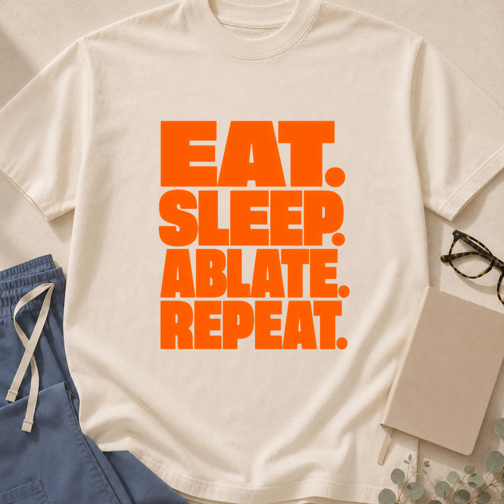 Garment-dyed unisex t-shirt printed with "Eat Sleep Ablate" — electrophysiology humor tee for cardiology fellows