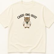 Garment-dyed unisex t-shirt featuring an illustrated Cardi-OWL-ogist design — a Cardiology humor tee.