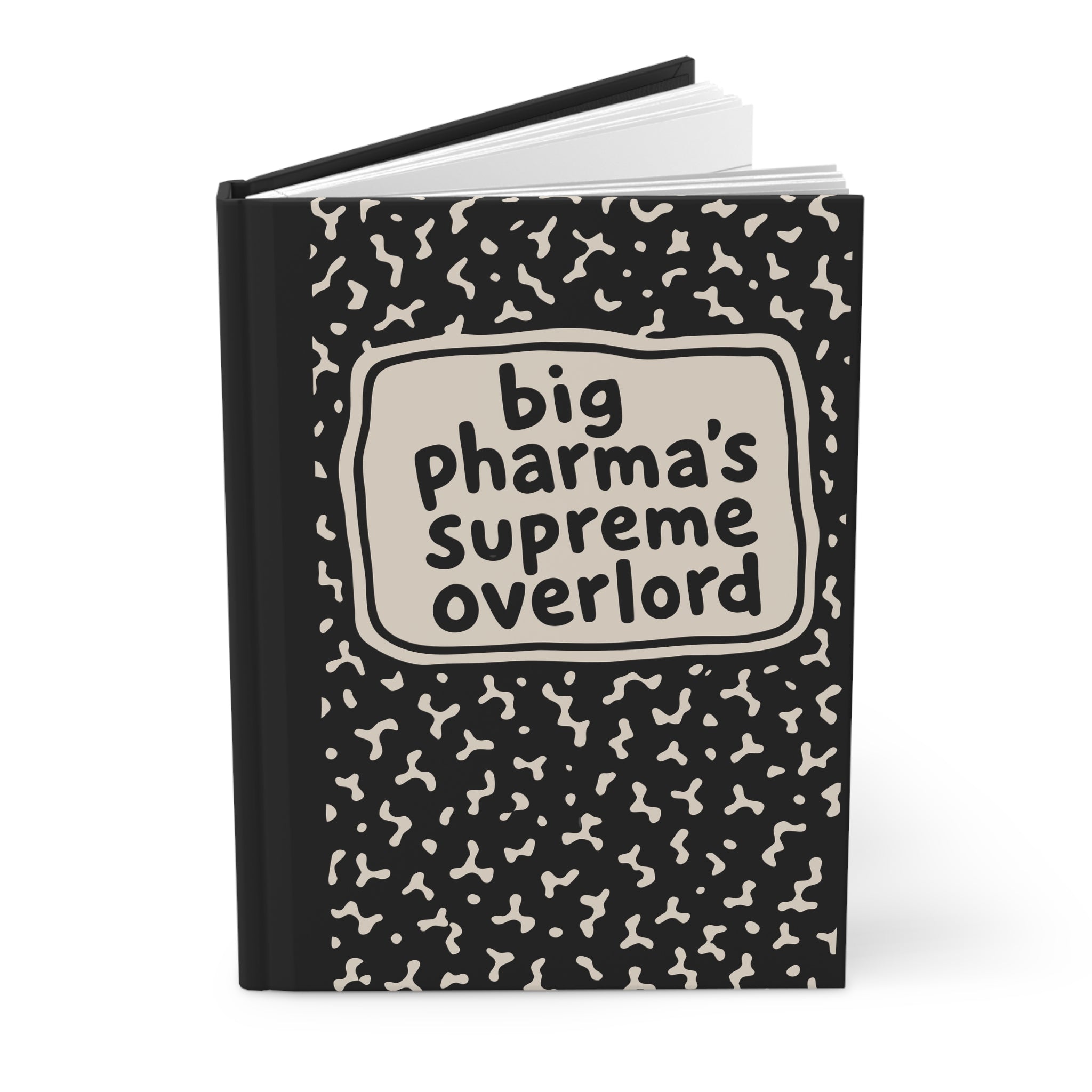 Angled view of black hardcover journal, cover reads 'big pharma's supreme overlord', pages visible