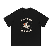 Mockup of a black cotton T-shirt with an astronaut floating between the words 'Lost in K Space'