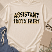 Garment-dyed unisex t-shirt printed with "Assistant Tooth Fairy" — dental humor tee for dental assistants and hygienists