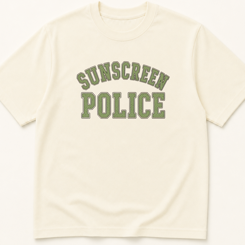 Garment-dyed unisex t-shirt printed with 'Sunscreen Police' — Dermatology humor tee for Family Medicine, Pediatrics, and Preventive Medicine professionals.