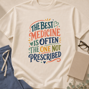 Garment-dyed unisex t-shirt printed with 'The Best Medicine is Often the One Not Prescribed' — primary care humor tee.