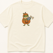 Garment-dyed unisex t-shirt featuring an illustrated Frog in Pumpkin Costume Holding Bag Mask Ventilation design — Anesthesiology humor tee for Critical Care, Emergency Medicine, and EMS/Paramedic professionals.