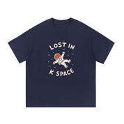 Mockup of a navy blue cotton T-shirt with an astronaut floating between the words 'Lost in K Space'
