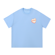 Mockup of blue cotton T-shirt with a candy heart reading "Reassuring".