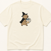 Garment-dyed unisex t-shirt featuring an illustrated Capybara in Witch Costume Holding a Suction Canister design — Nursing humor tee for Surgery and Surgical Technology professionals.