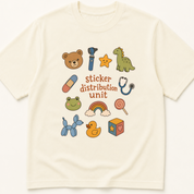 Garment-dyed unisex t-shirt printed with 'Sticker Distribution Unit' — Child Life humor tee for Emergency Medicine, Nursing, and Pediatrics professionals.