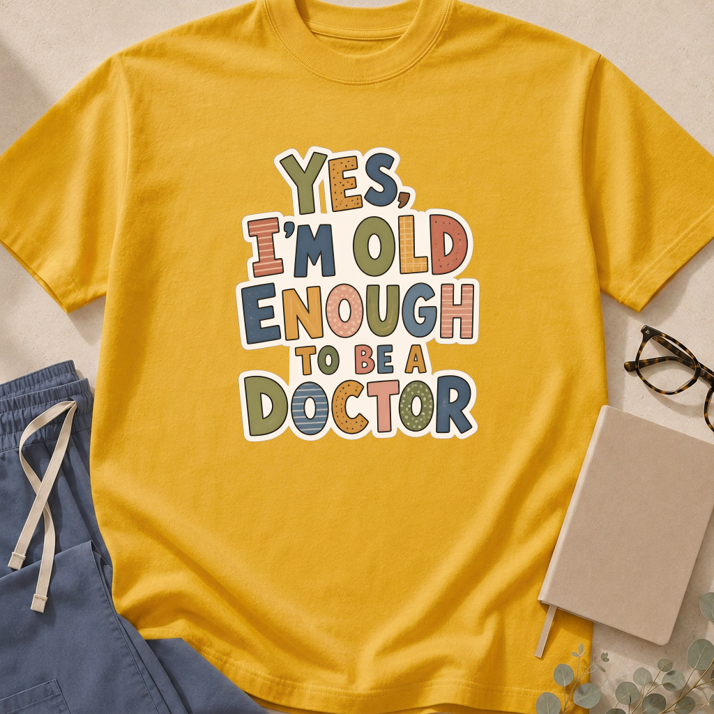 Alternate view of the 'Yes, I'm Old Enough to Be a Doctor' garment-dyed t-shirt in the Mustard colorway.