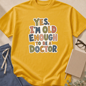 Alternate view of the 'Yes, I'm Old Enough to Be a Doctor' garment-dyed t-shirt in the Mustard colorway.