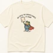 Garment-dyed unisex t-shirt printed with 'Check the Growth Charts at Dawn' — Family Medicine humor tee for Neonatology and Pediatrics professionals.