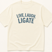 Garment-dyed unisex t-shirt printed with 'Live Laugh Ligate' — Surgery humor tee for Surgical Technology professionals.