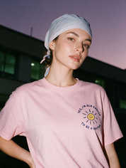 Woman photographed at night wearing a pink cotton T-shirt with 'Yes, I'm Old Enough to Be a Doctor' design.