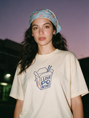 Woman photographed at night wearing an apricot cotton T-shirt with 'I Love PO Intake' design.