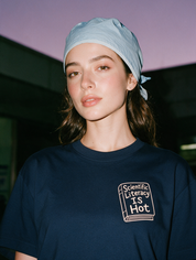 Woman photographed at night wearing a navy blue cotton T-shirt with 'Scientific Literacy Is Hot' design.