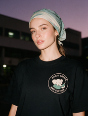Woman photographed with flash at night wearing a black cotton T-shirt with 'Nasal Saline and Suction' design.