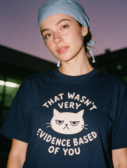 Woman photographed with flash at night wearing a navy blue cotton T-shirt with 'That Wasn't Very Evidence Based Of You' design.