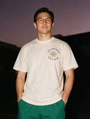 Man photographed with flash at night, wearing an apricot cotton T-shirt with the Yes, I'm Old Enough to Be a Doctor design.
