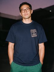 Man photographed with flash at night, wearing a navy blue cotton T-shirt with the Scientific Literacy Is Hot design.