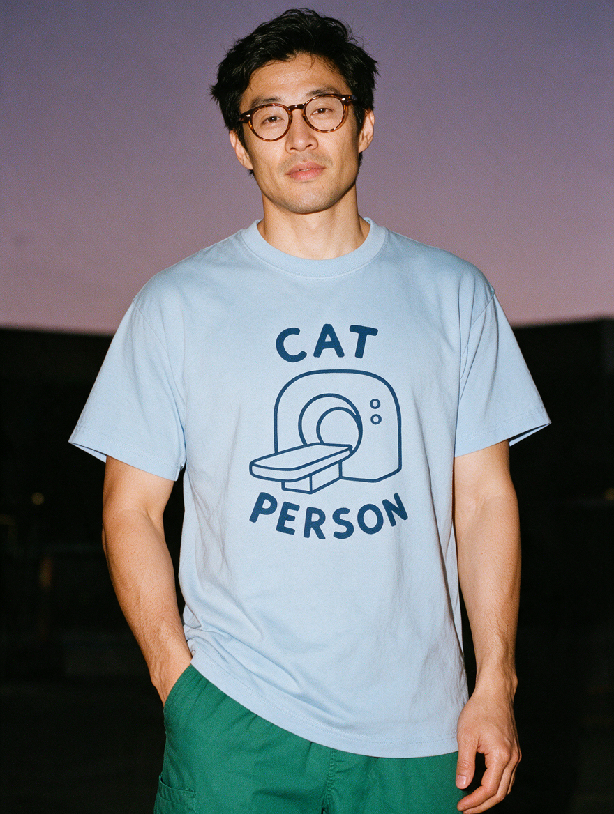 Man photographed with flash at night, wearing a blue cotton T-shirt with the Cat Person design.